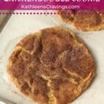Baked snickerdoodle cookie on a baking sheet.