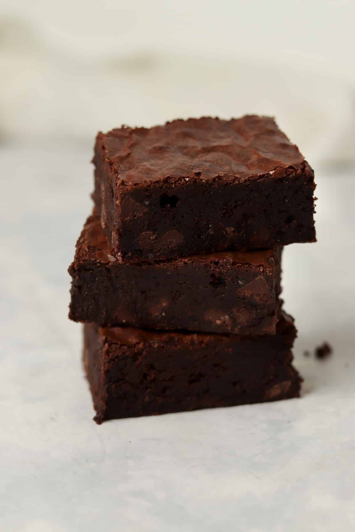 Stack of three fudgy chocolate brownies.