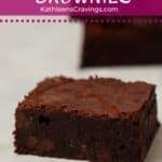 Fudgy brownie cut into a square to show center and crinkly top.