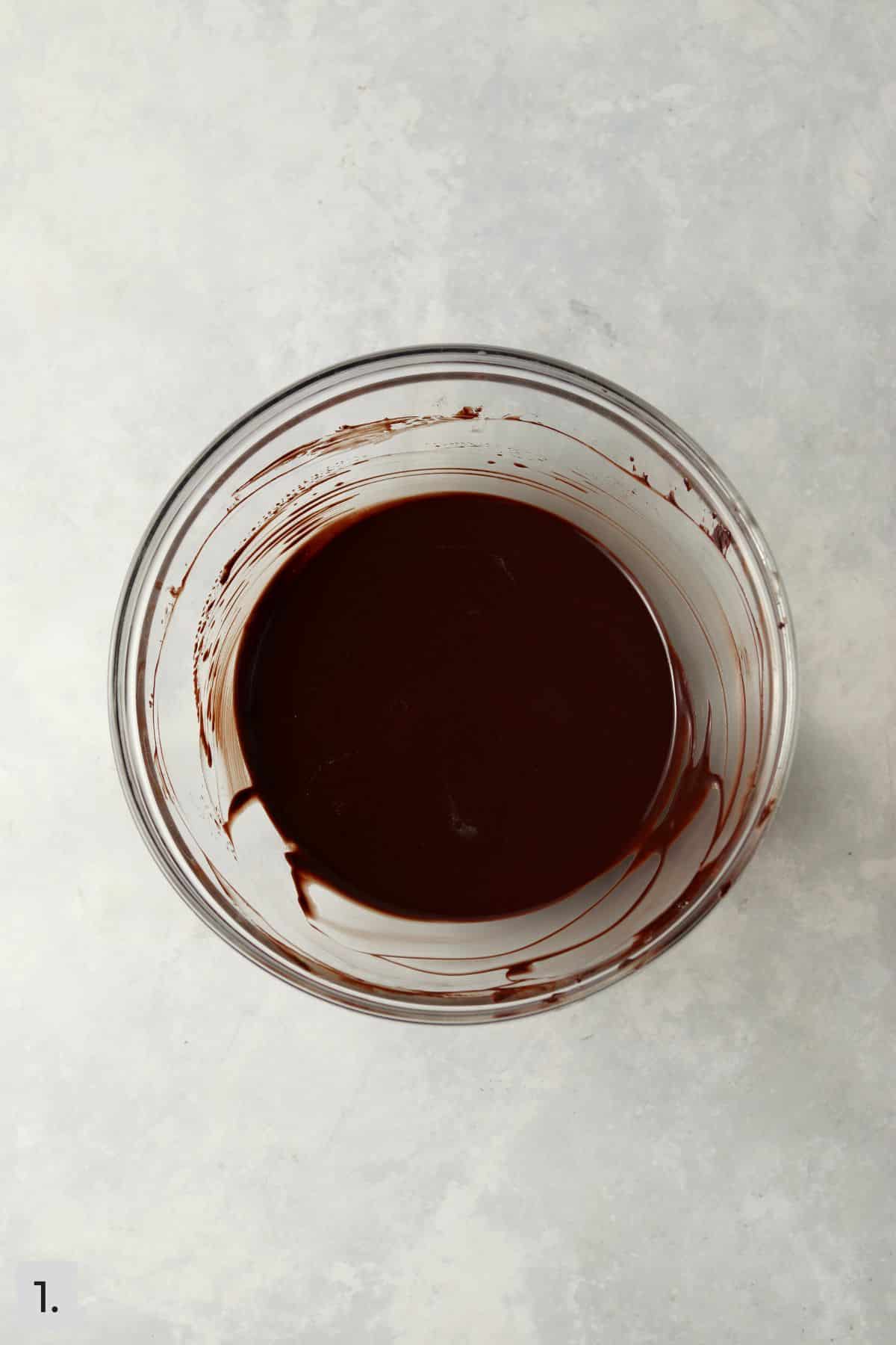 Melted chocolate and butter in glass mixing bowl.