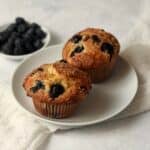 Single serve blueberry muffins with fresh blueberries.