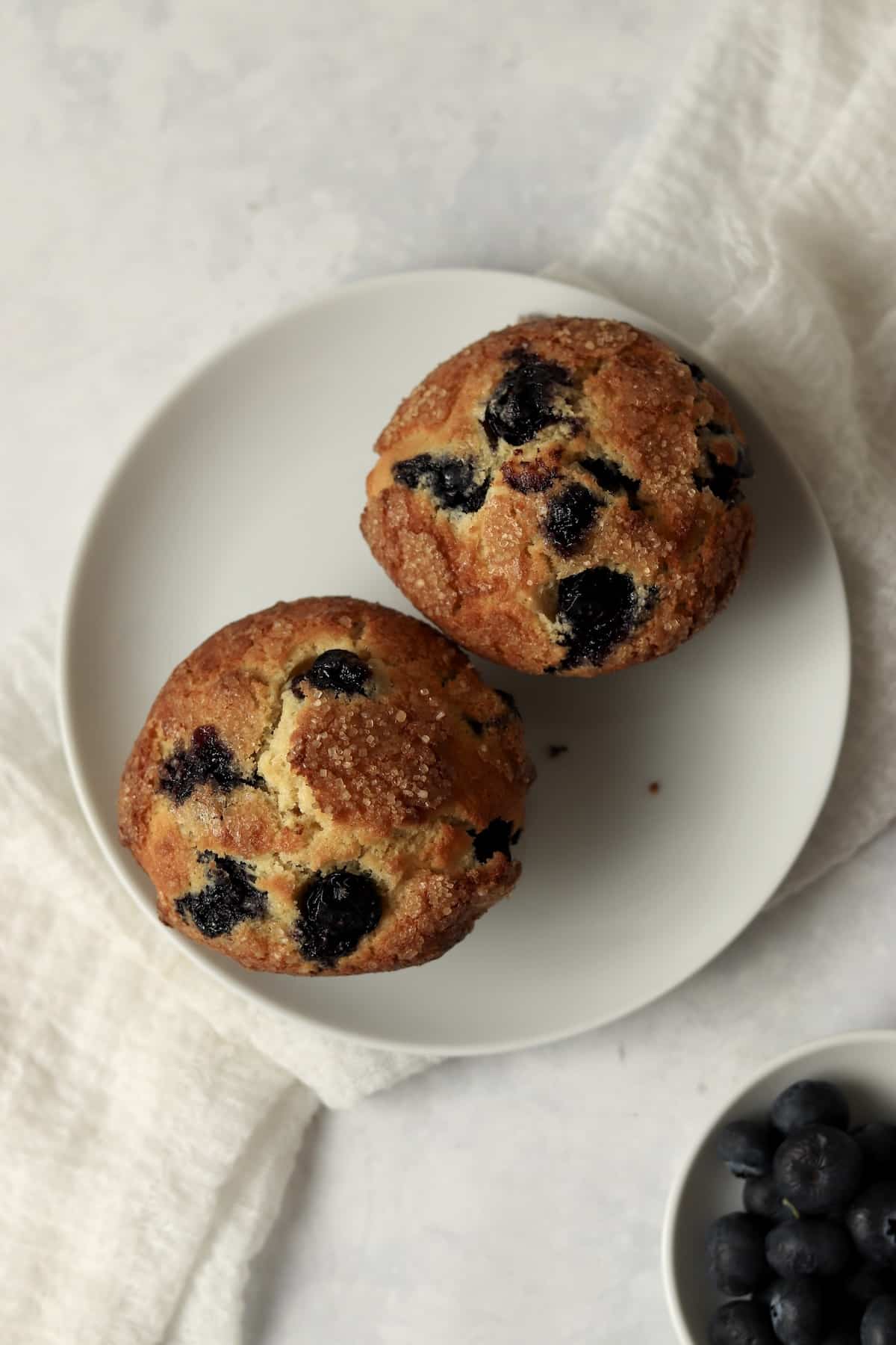 Single serve blueberry muffins on a small plate.