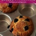 Two blueberry muffins baked in the pan.