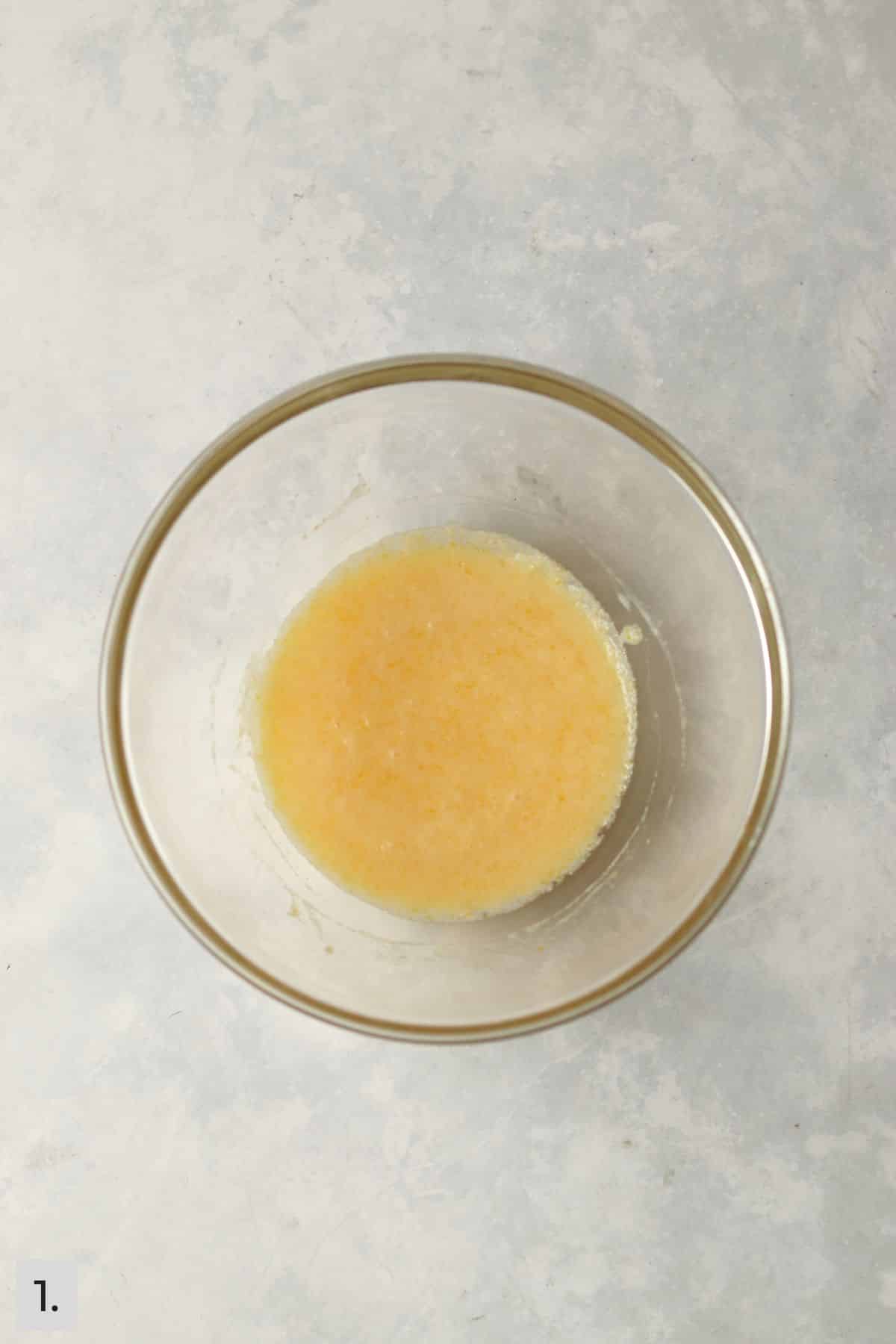 Wet ingredients for muffins mixed in a medium bowl.