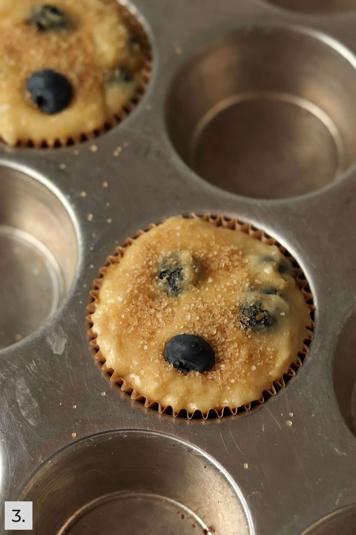 Unbaked single serve blueberry muffins in the pan.