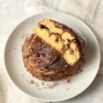 Single serve cinnamon swirl cake cut in half to show cinnamon sugar center.