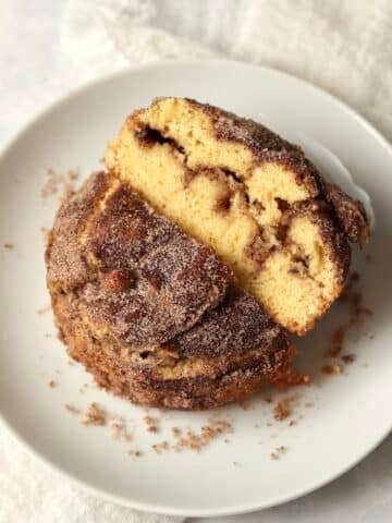 Single serve cinnamon swirl cake cut in half to show cinnamon sugar center.