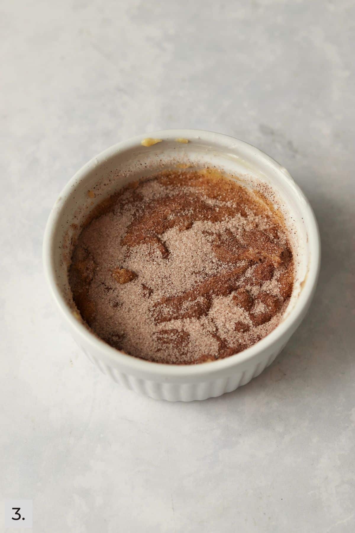 Unbaked cinnamon swirl cake in a ramekin.