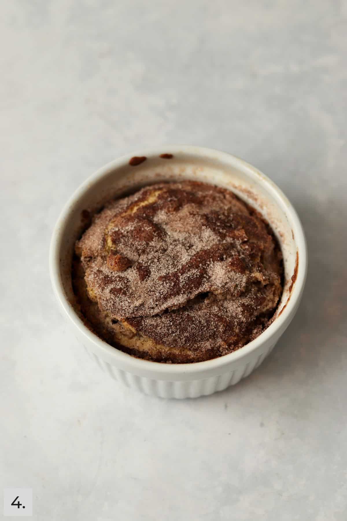 Baked cinnamon swirl cake in a ramekin.