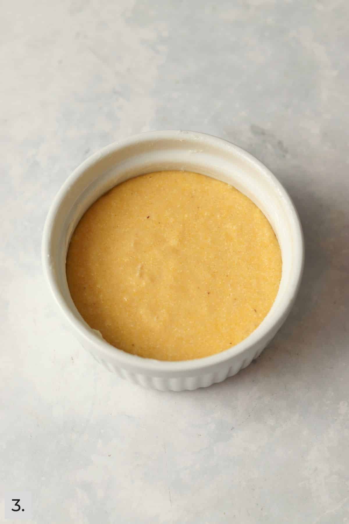 Unbaked single serve cornbread in a ramekin.