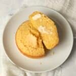 Single serve cornbread on a plate cut in half.