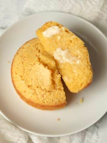 Single serve cornbread on a plate cut in half.