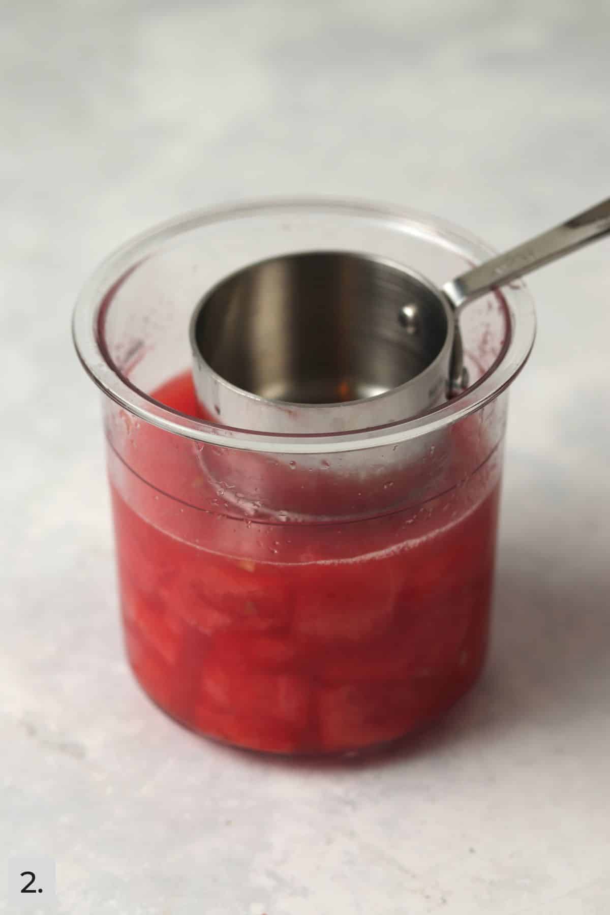 Mashed watermelon in a pint container.