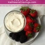 Single serve fruit dip on a plate with berries.