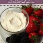 An individual serving of fruit dip with berries.
