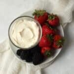 Single serve fruit dip on a plate with berries.
