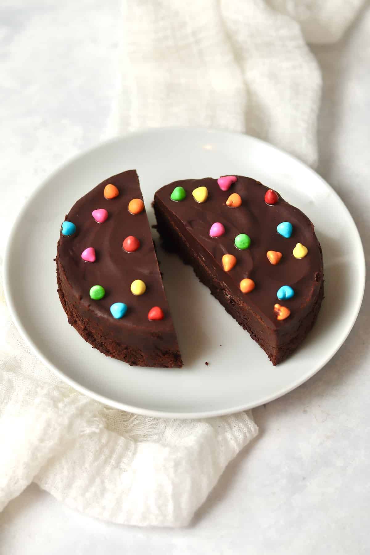 Single serve cosmic brownie with rainbow chips on a small plate.