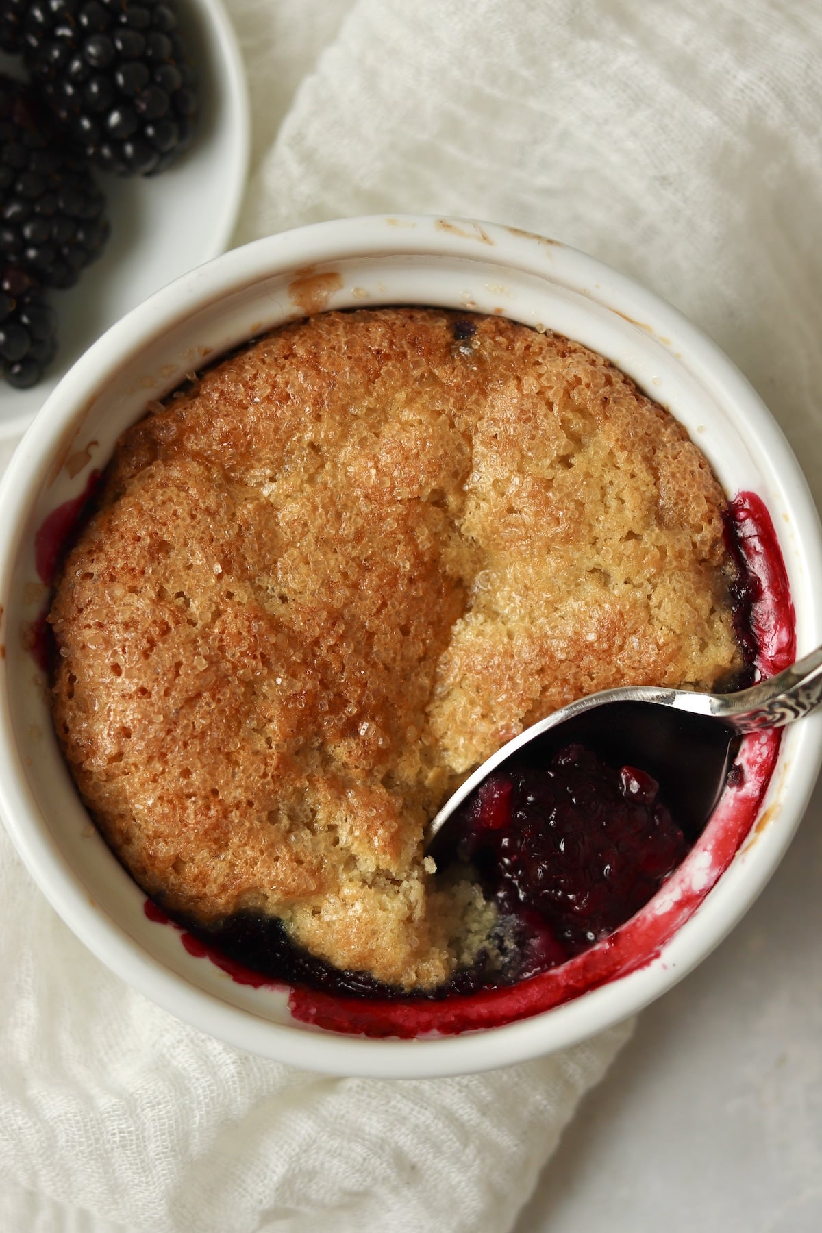 Single serve blackberry cobbler baked in a ramekin.