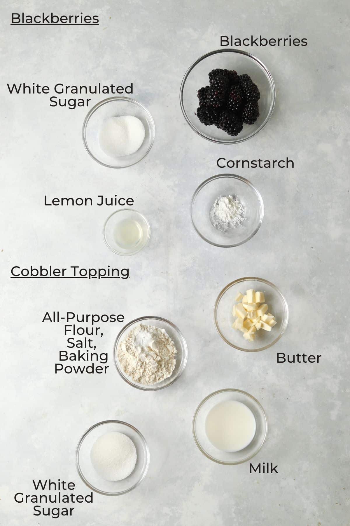 Ingredients to make a single serve blackberry cobbler in small glass prep bowls.