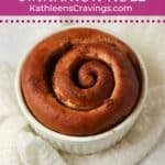 Baked single cinnamon roll in a ramekin.