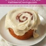 Single serve cinnamon roll with icing on a plate.
