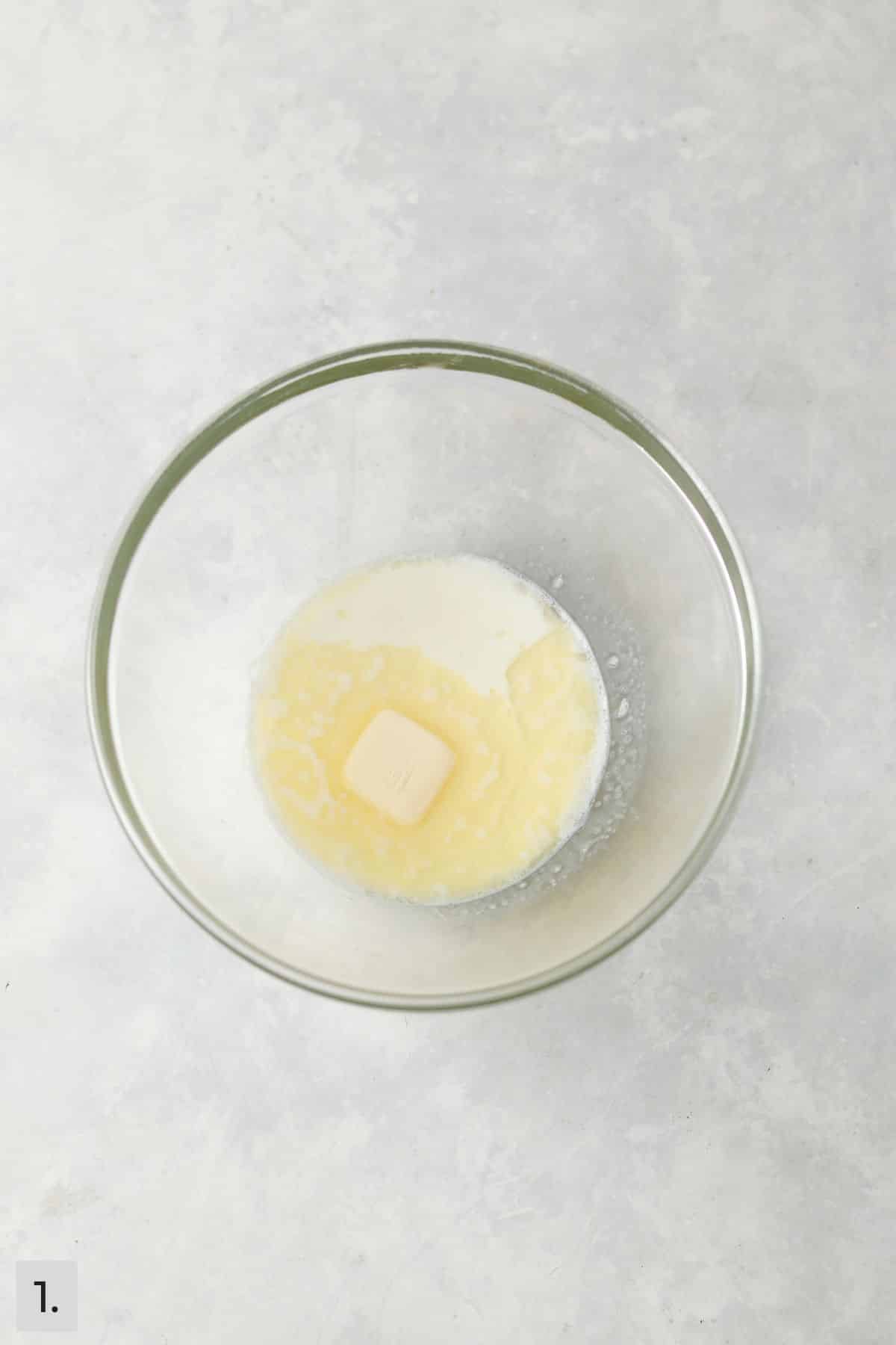Butter and milk warmed in a glass bowl.
