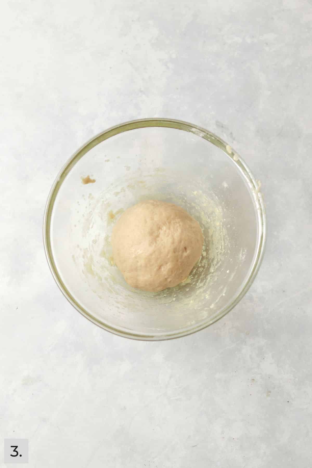 Small batch of dough in a glass bowl.