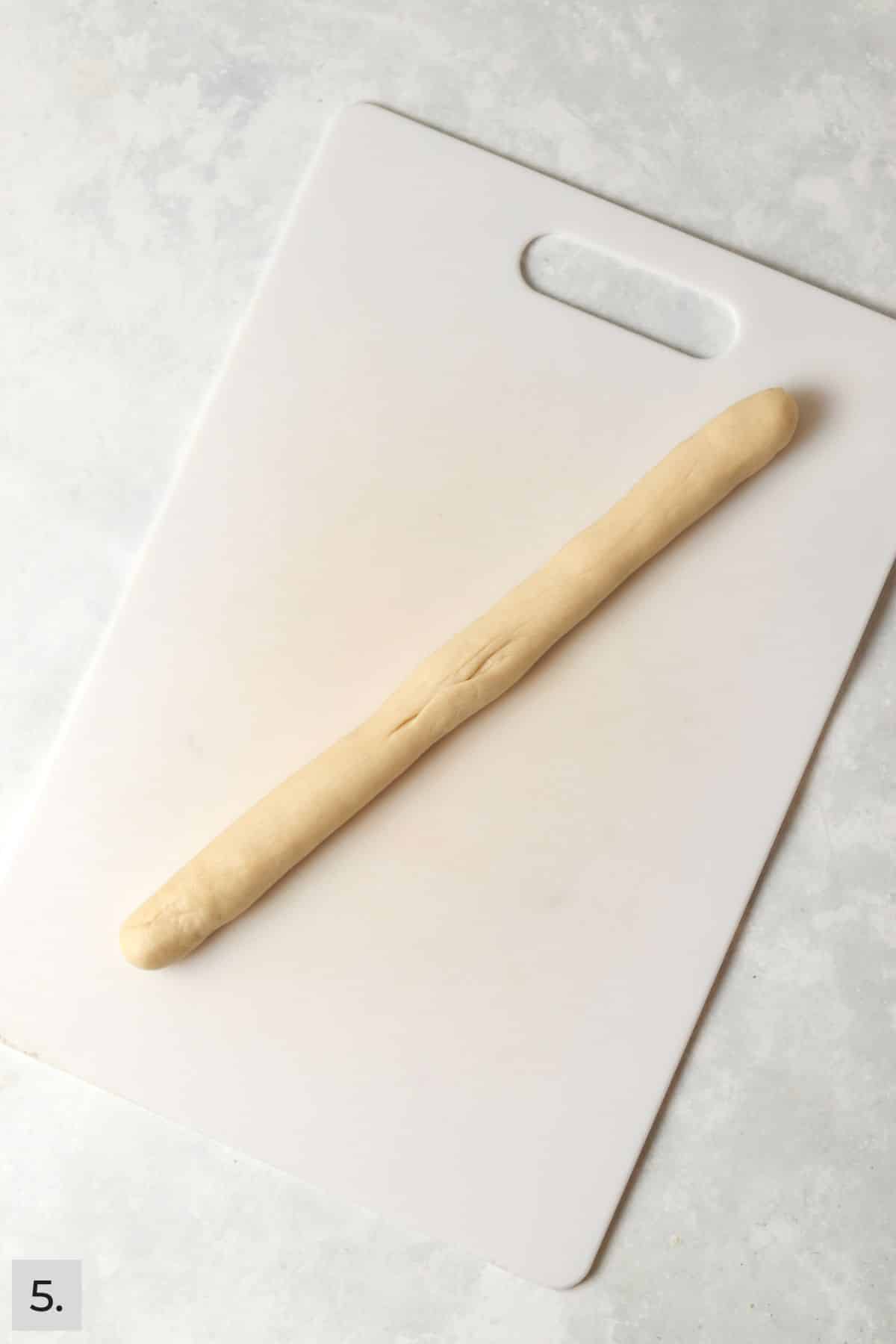 Cinnamon roll dough rolled into a log.
