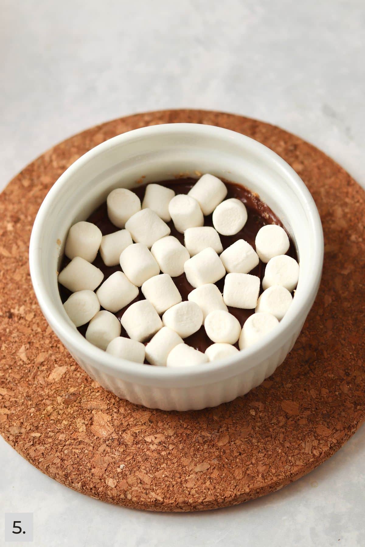 S'mores bar with mini marshmallows in a ramekin before baking.