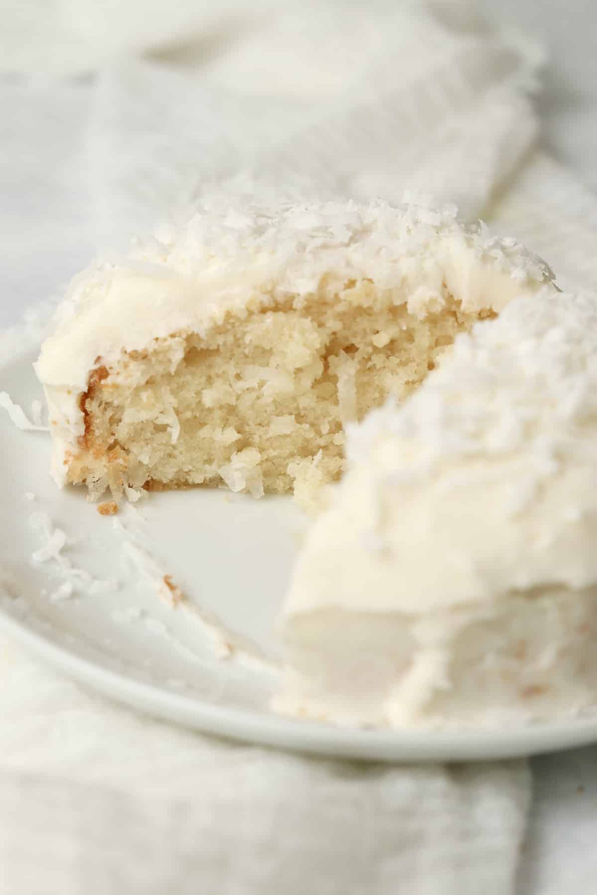 Single serve coconut cake with coconut frosting on a plate.
