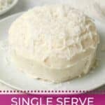 Single serve coconut cake baked in a ramekin with coconut frosting on a plate.