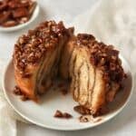Single serve pecan sticky bun on a plate.