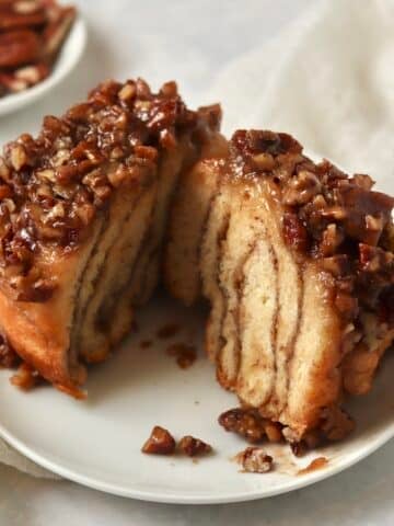 Single serve pecan sticky bun on a plate.