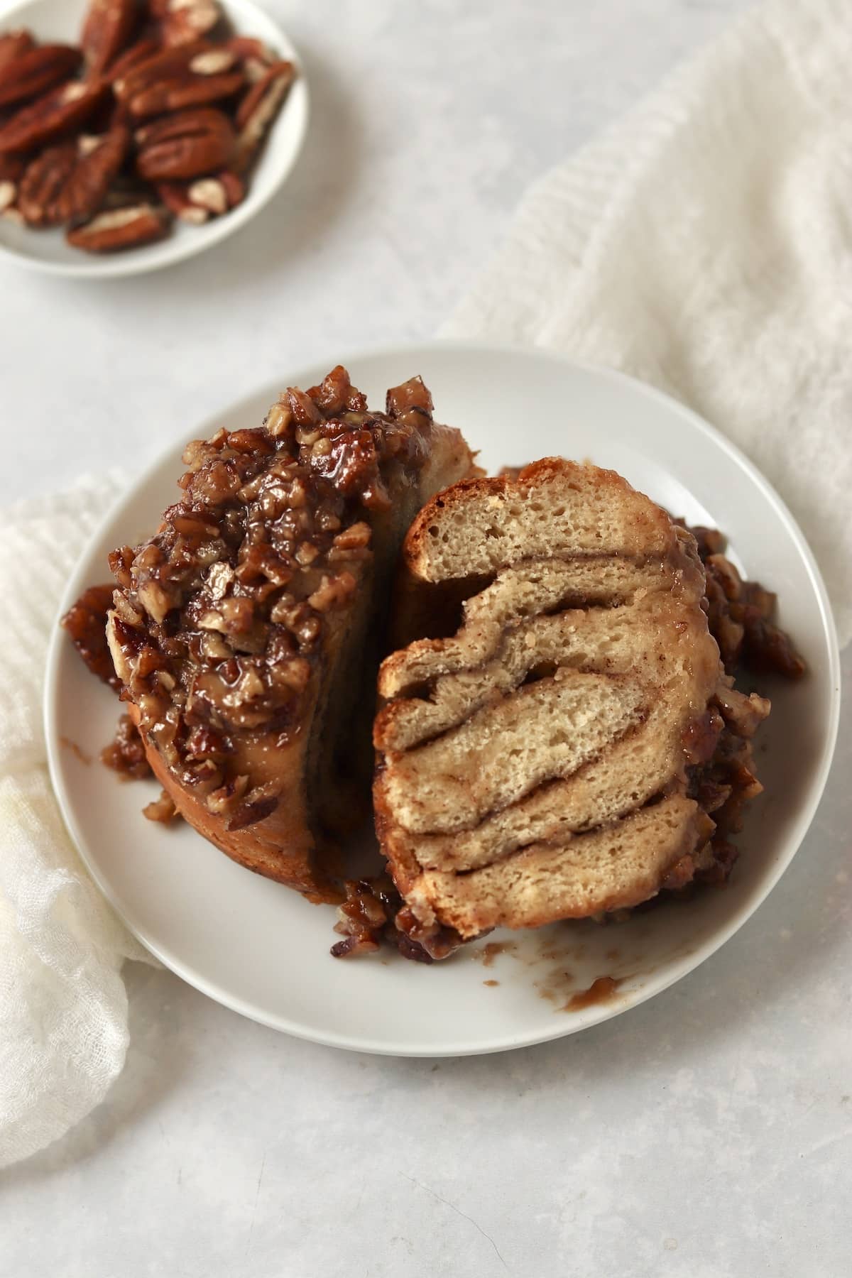 Single serve pecan sticky bun on a plate.