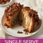 Single serve pecan sticky bun cut in half on a plate.