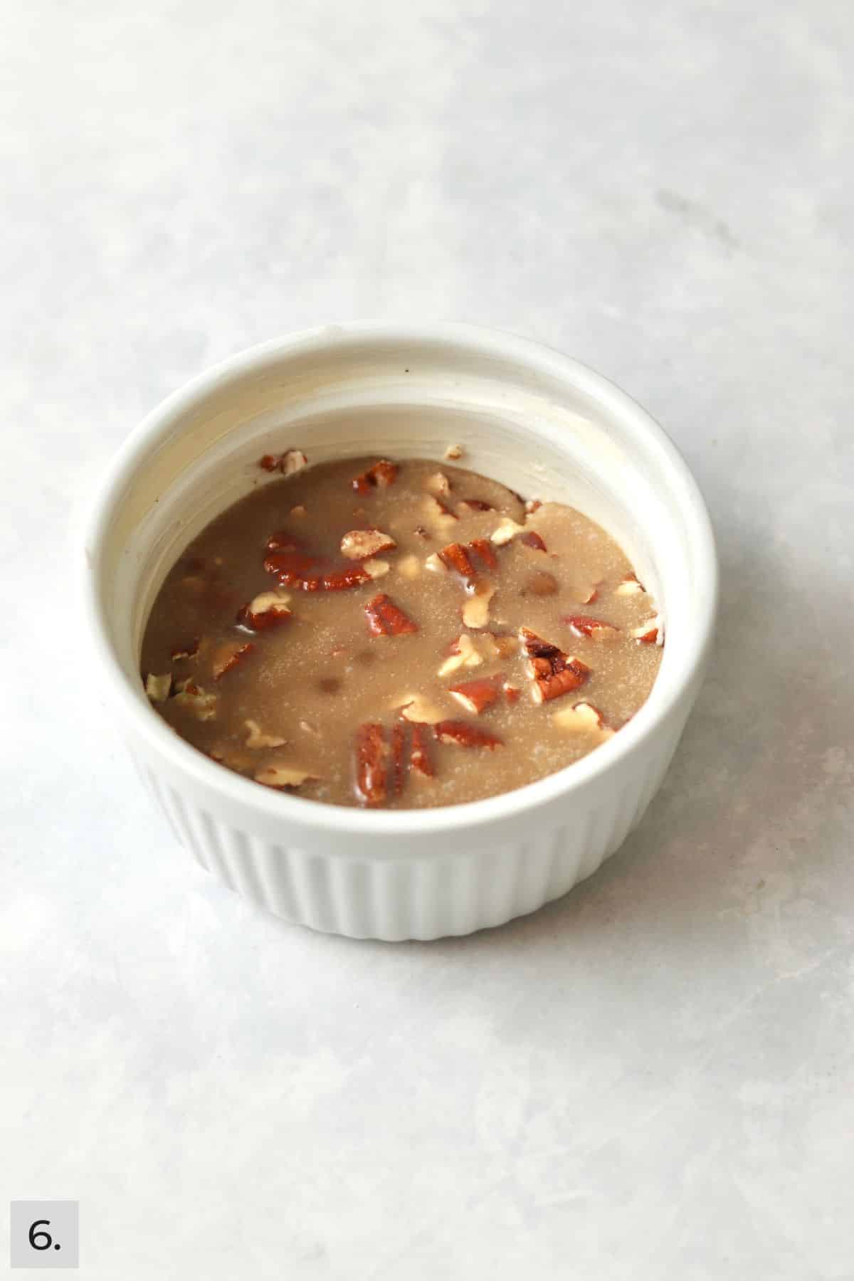 Pecan and caramel topping in a ramekin.