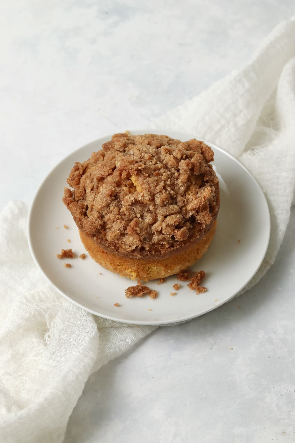 Single serve pumpkin coffee cake with streusel on a plate.