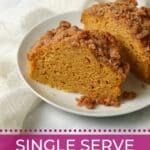 Single serve pumpkin coffee cake cut in half on a plate.