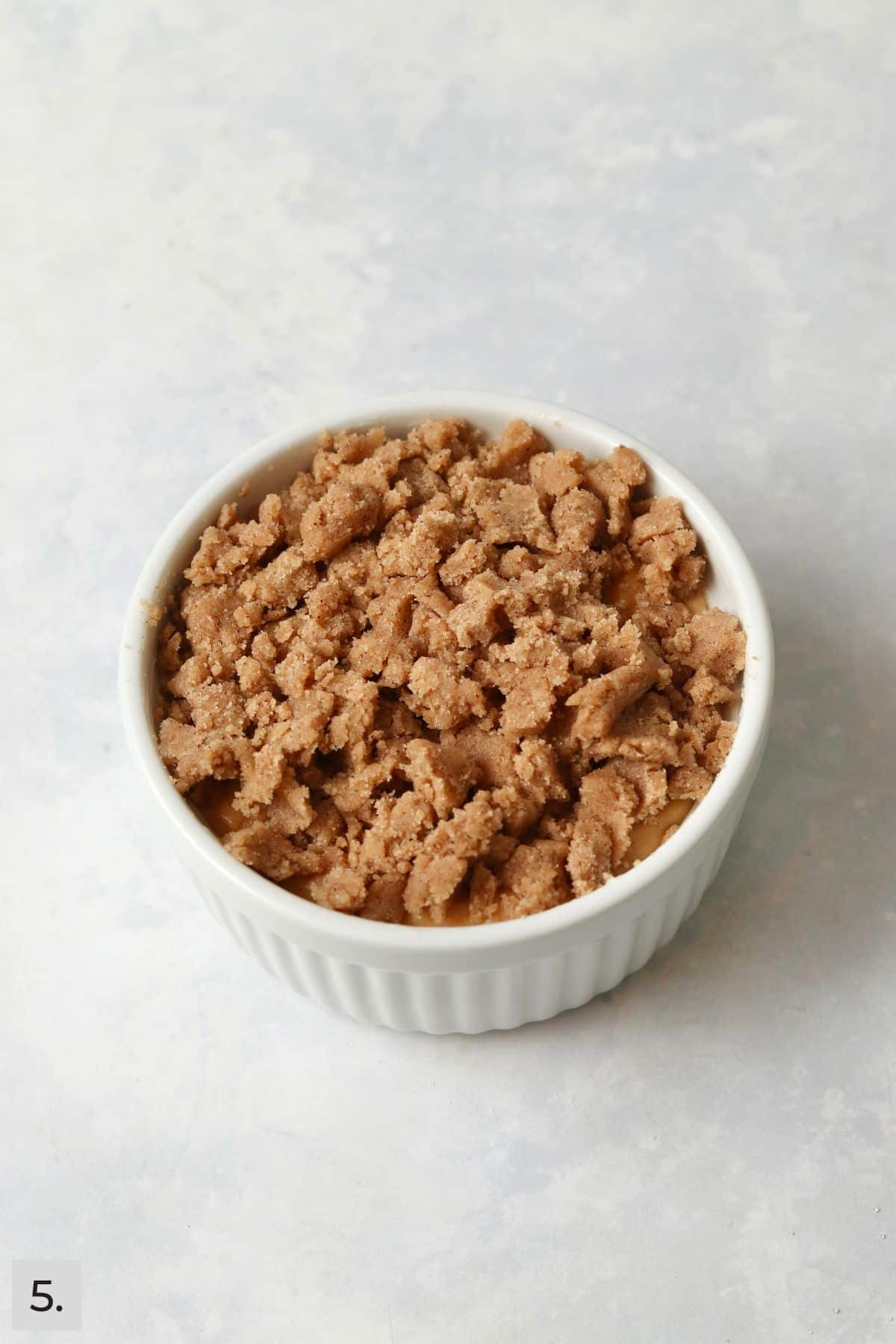 Unbaked pumpkin streusel coffee cake in a ramekin.