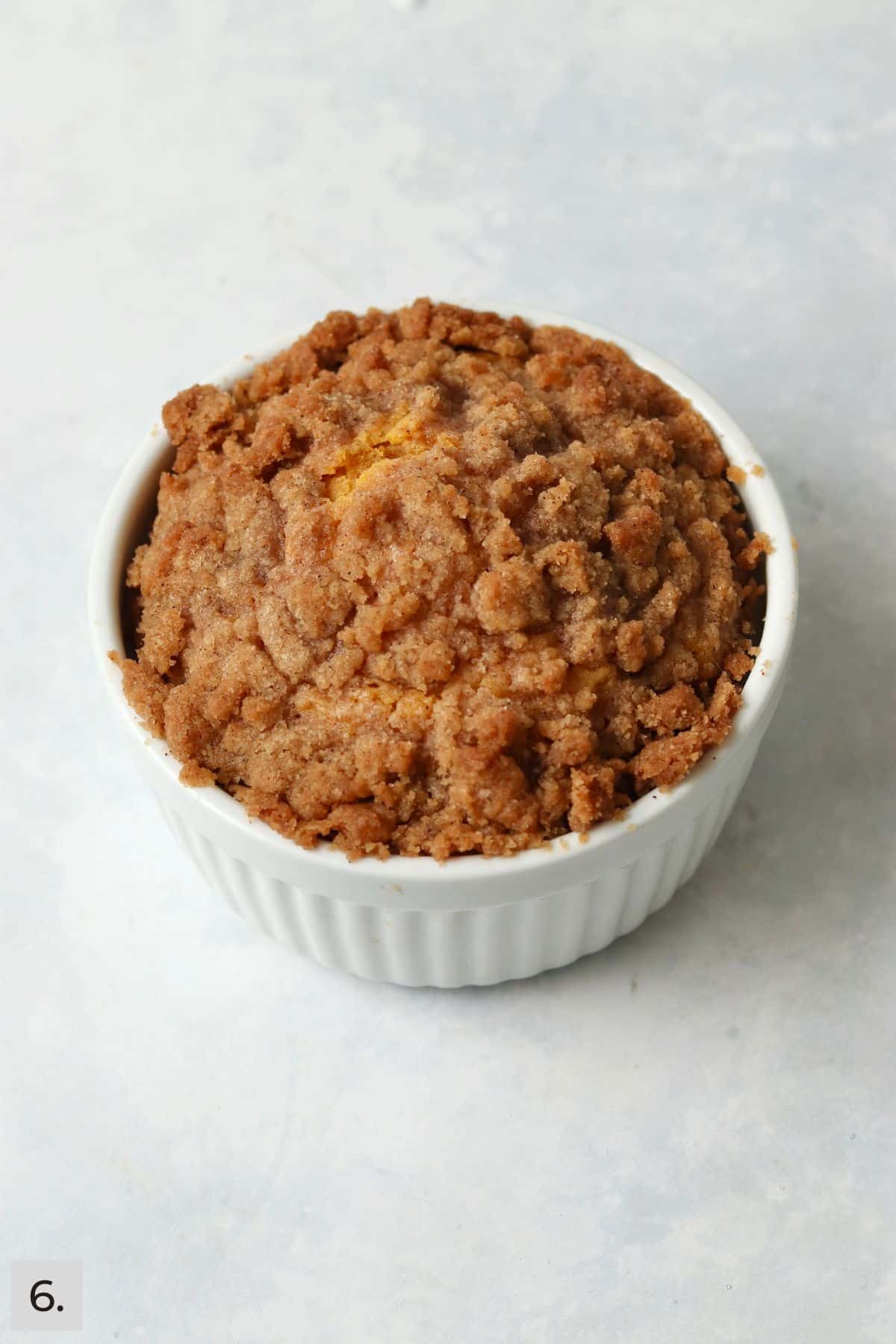 Baked pumpkin coffee cake with streusel in a ramekin.