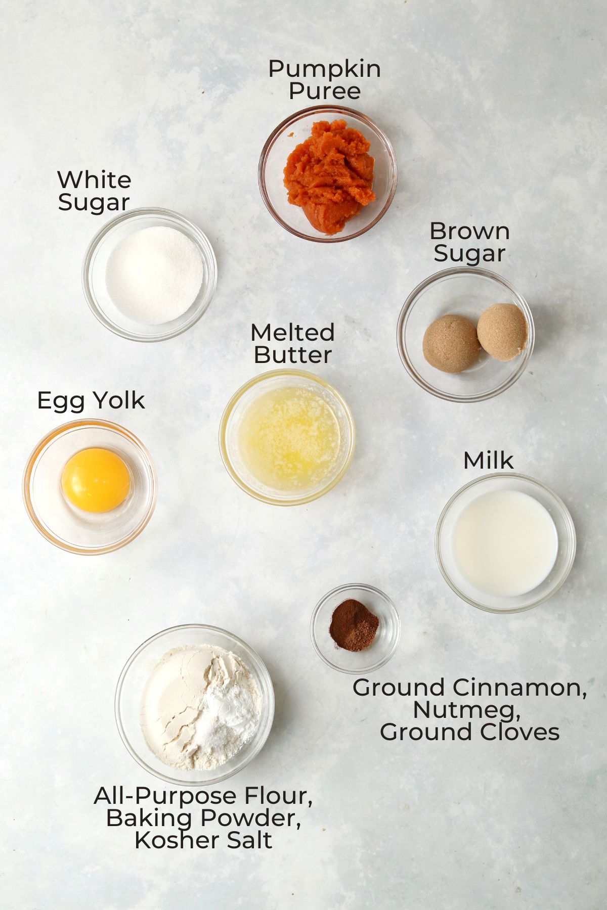 Single serve pumpkin muffin ingredients in glass prep bowls.