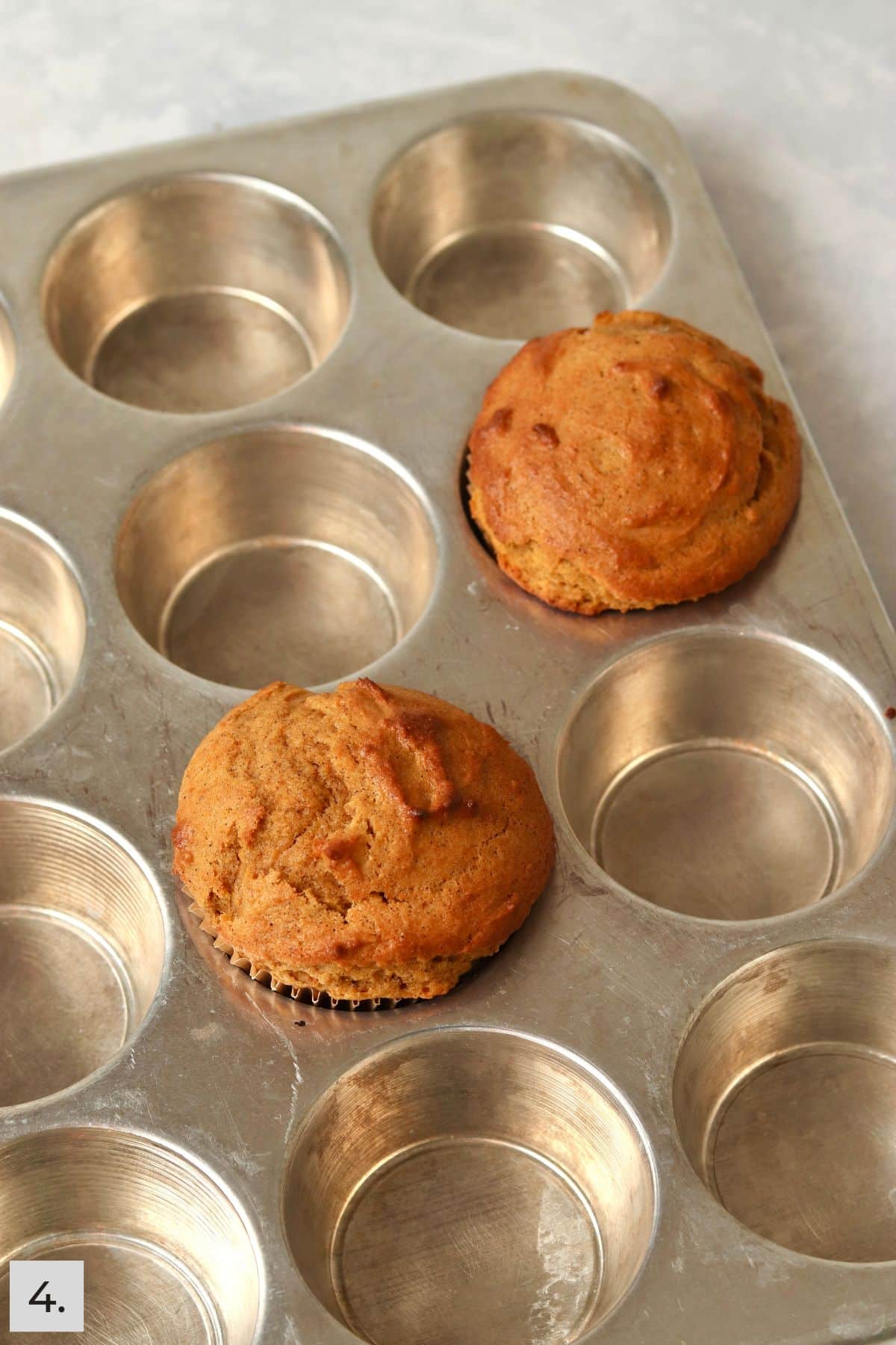 Single serve pumpkin muffins baked in a muffin pan.