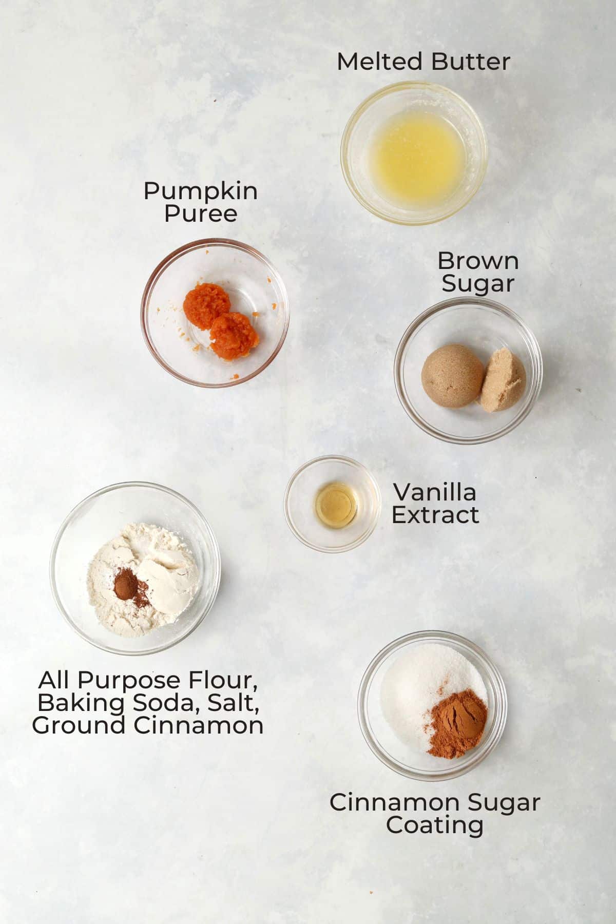 Pumpkin snickerdoodle cookie ingredients in small glass bowls.