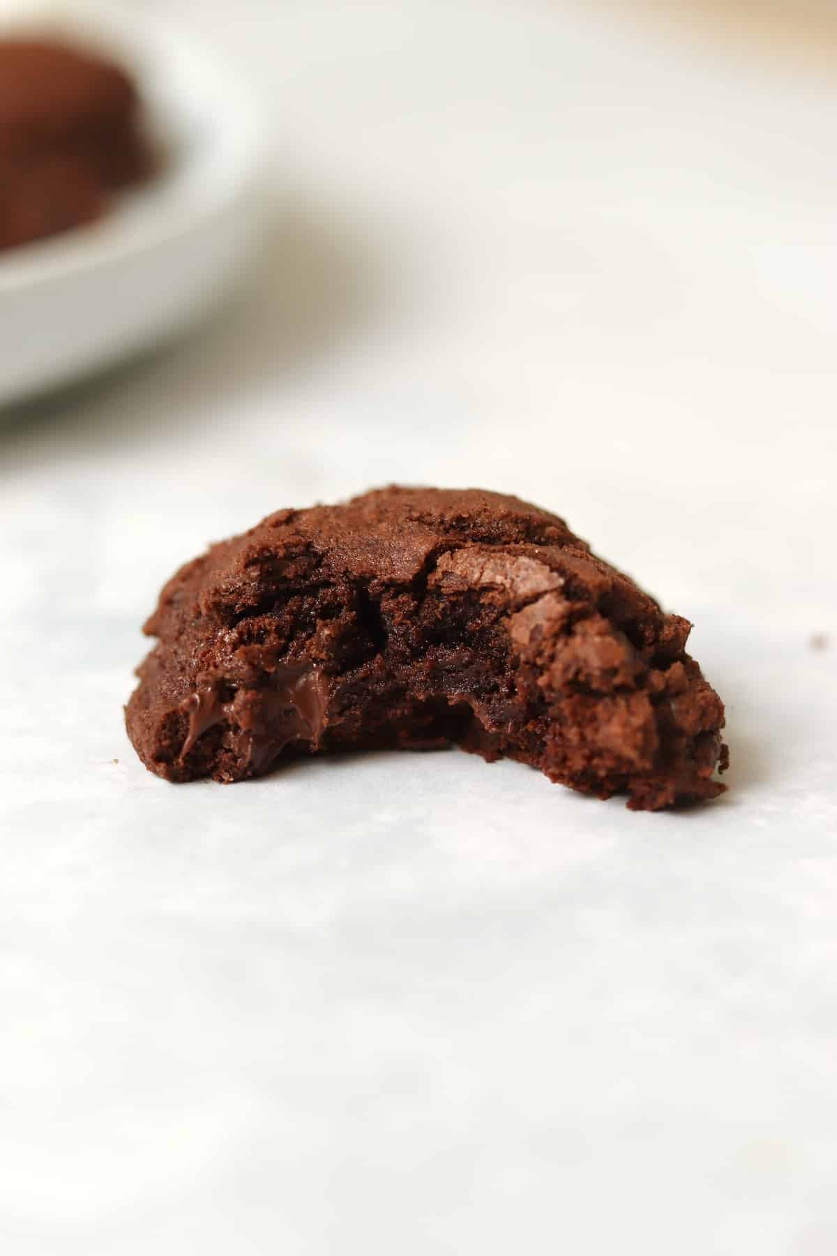 Brownie cookie with bite taken out to show fudgy center.