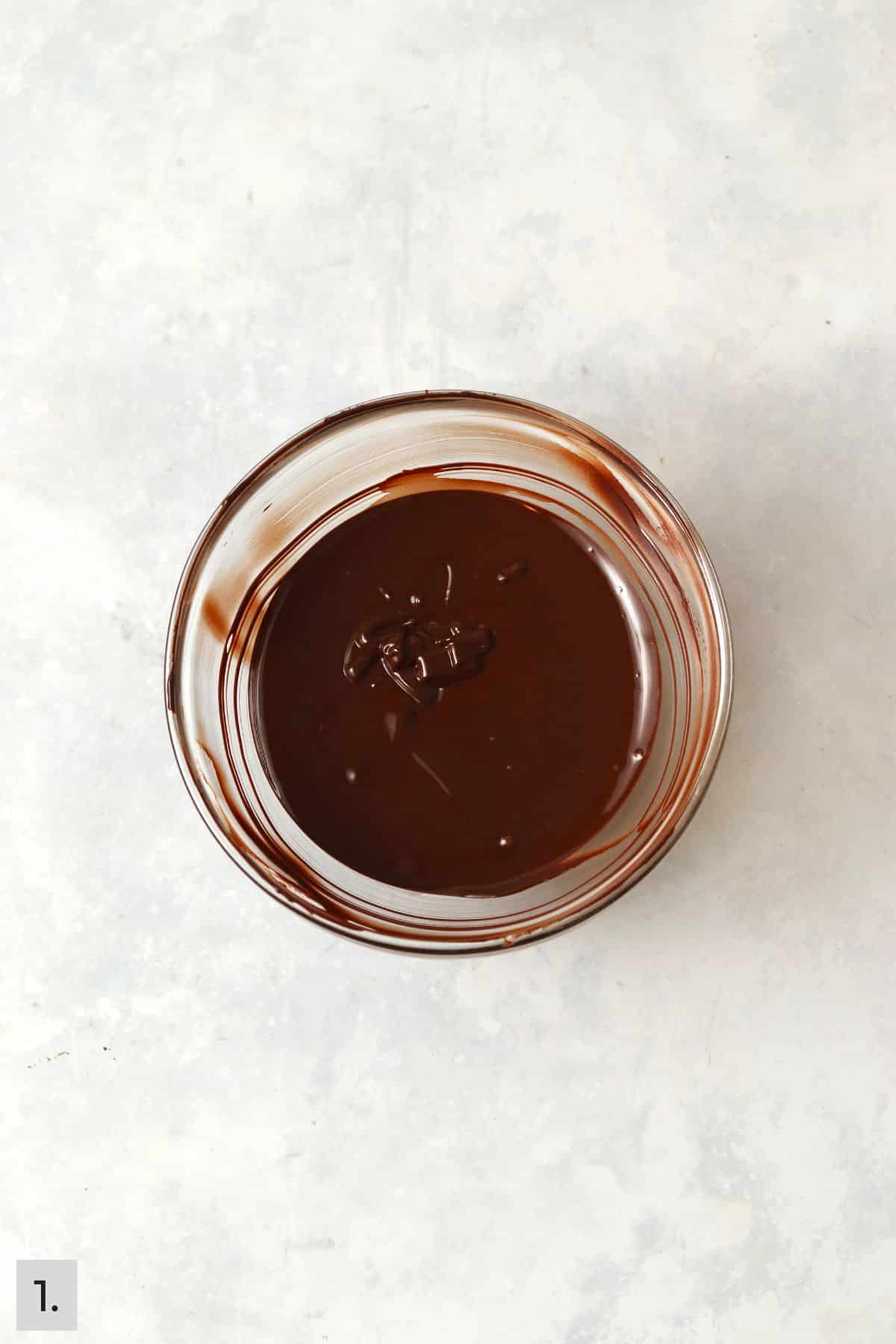 Melted chocolate in a glass bowl.