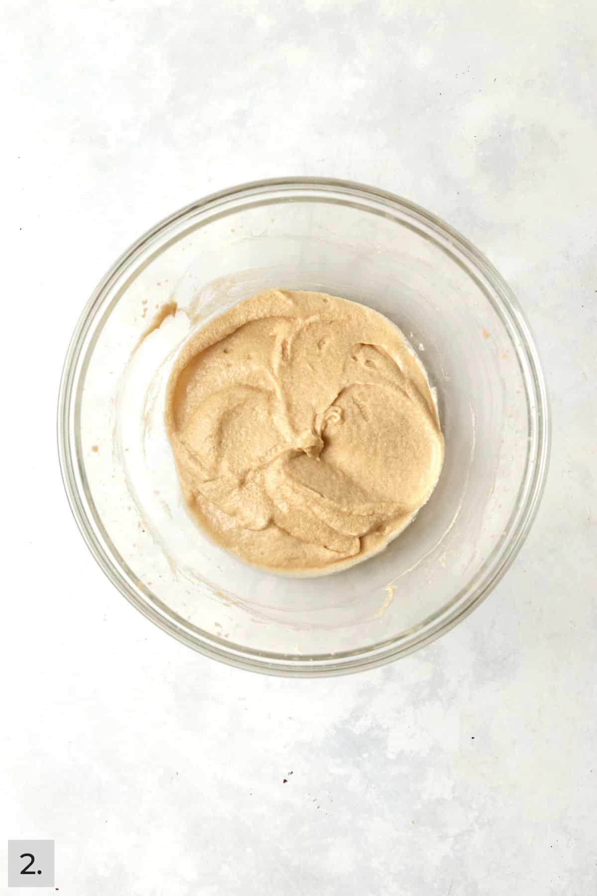 Creamed butter, sugar, brown sugar, egg, and vanilla in a glass mixing bowl.