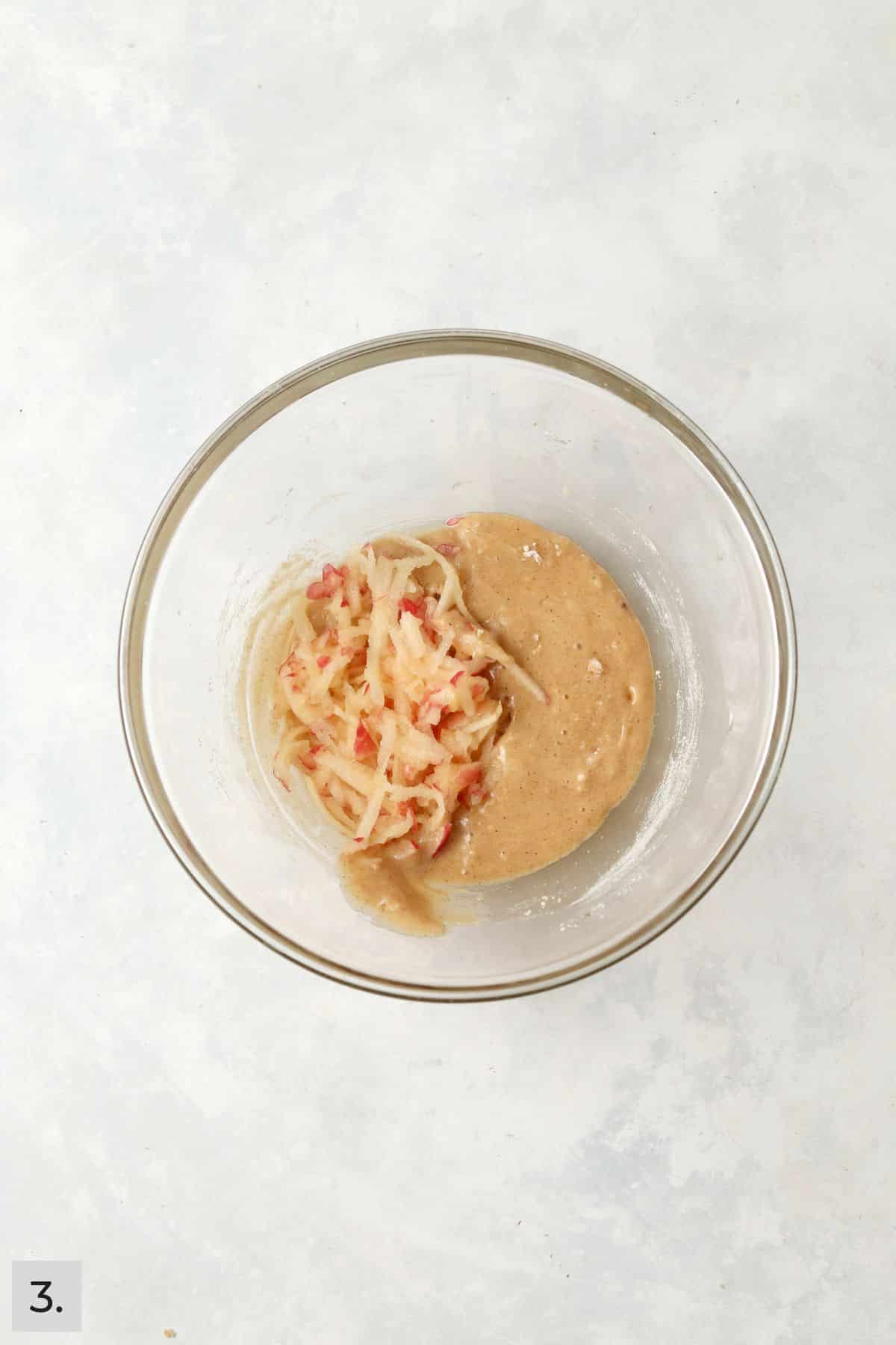 Cake batter with fresh grated apple on top.
