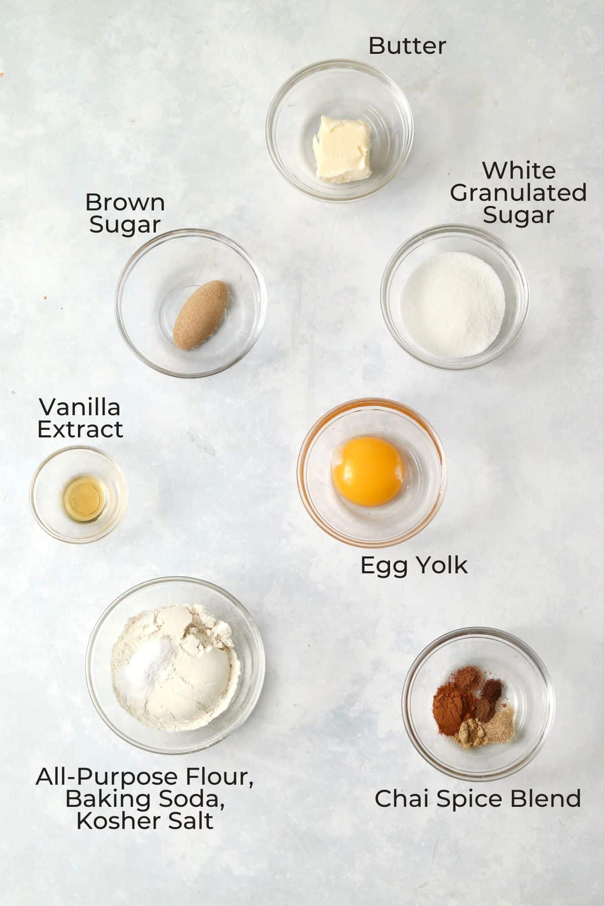 Ingredients to make single serve chai spiced cookies in small glass prep bowls.