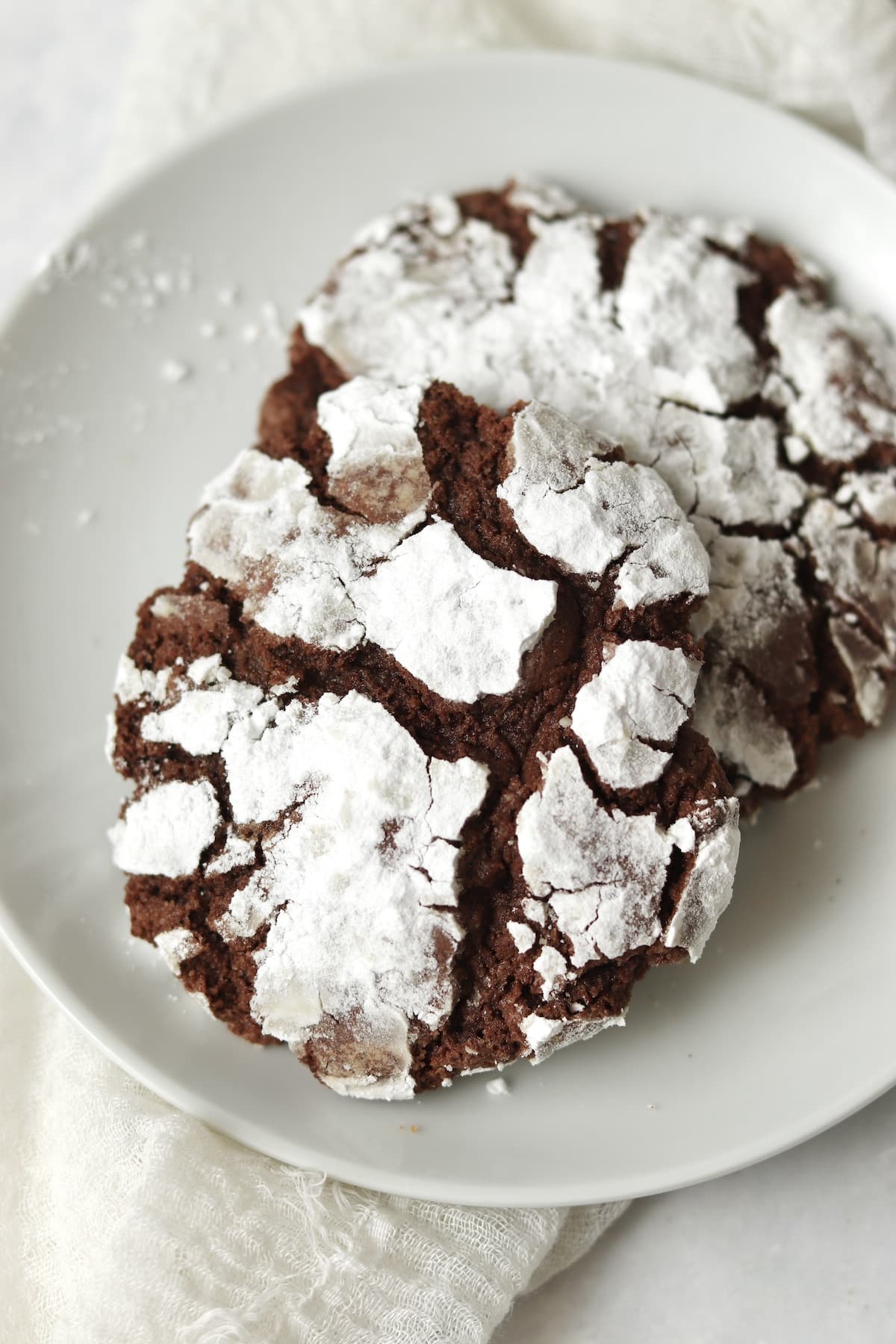 Single serve chocolate crinkle cookie on a small plate.