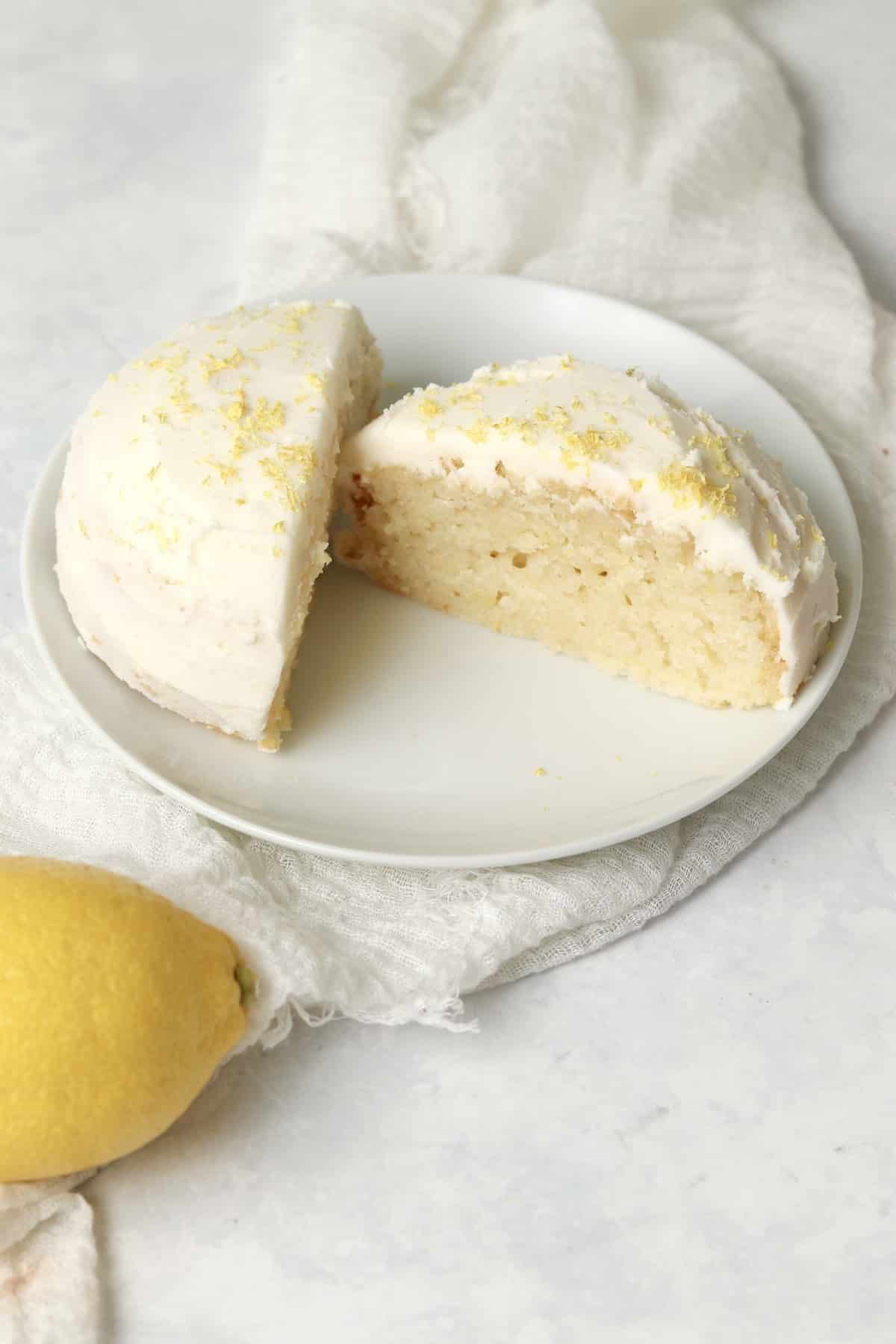 Single serve lemon cake with frosting on a small plate.